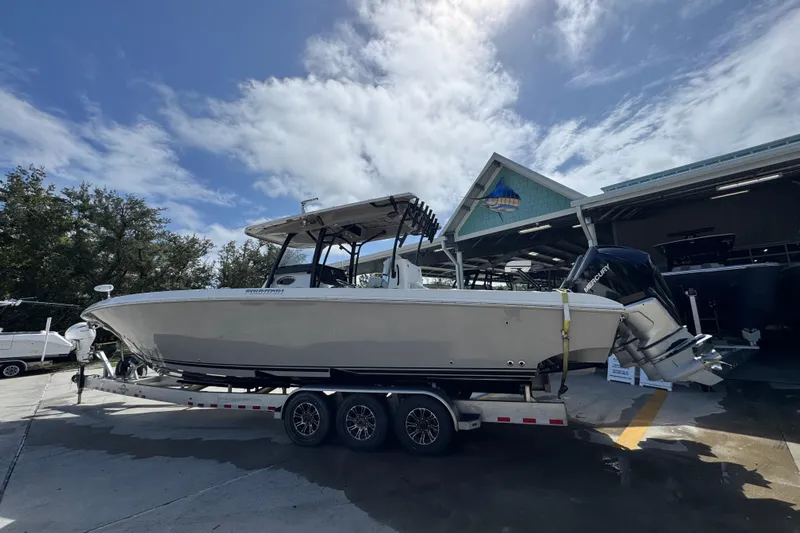  Yacht Photos Pics 2020 Fountain 38 Tournament Edition boat on trailer, parked outdoors under a partly cloudy sky.