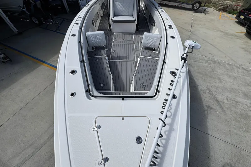  Yacht Photos Pics 2020 Fountain 38 Tournament Edition boat with spacious deck and seating, docked on concrete.