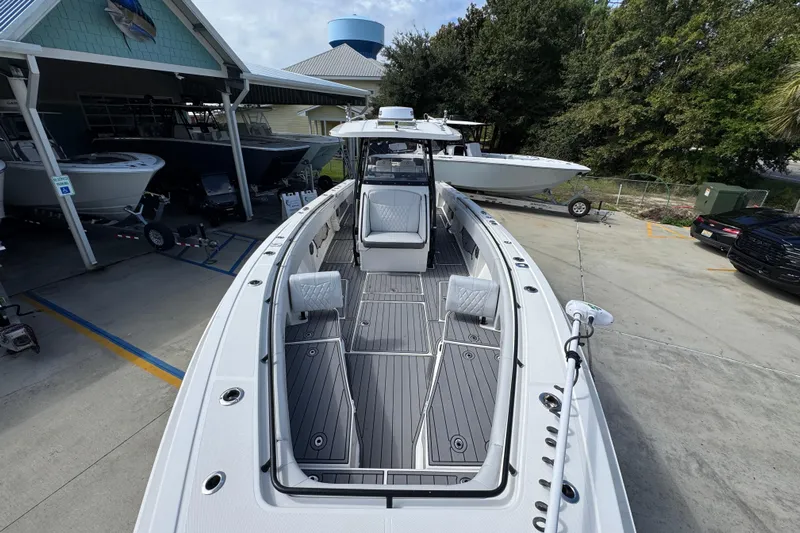  Yacht Photos Pics 2020 Fountain 38 Tournament Edition boat displayed at a marina with surrounding trees.