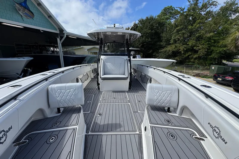  Yacht Photos Pics 2020 Fountain 38 Tournament Edition boat with spacious deck and seating, docked outdoors.