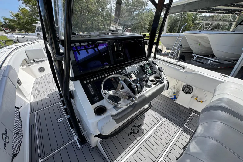  Yacht Photos Pics 2020 Fountain 38 Tournament Edition boat cockpit with modern controls and steering wheel.