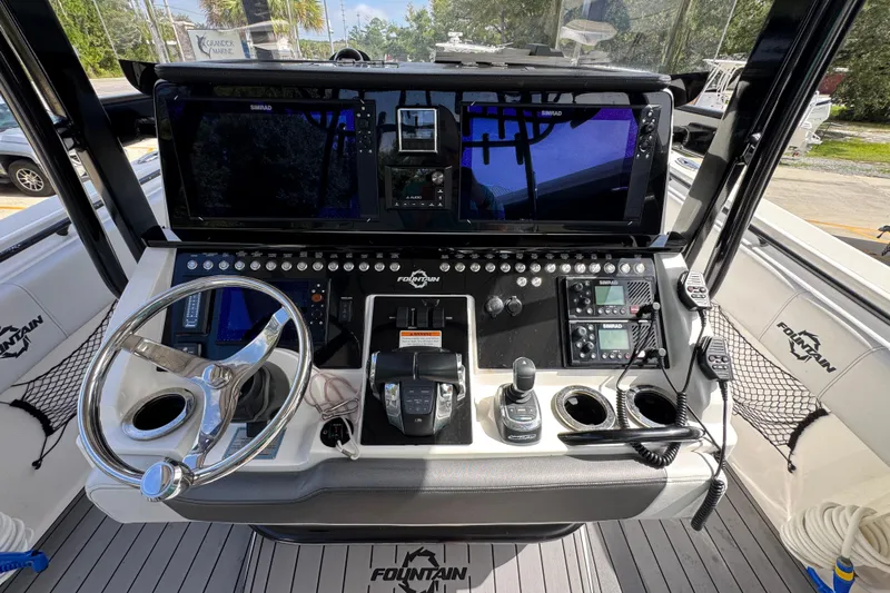 Yacht Photos Pics 2020 Fountain 38 Tournament Edition boat dashboard with steering wheel and navigation controls.