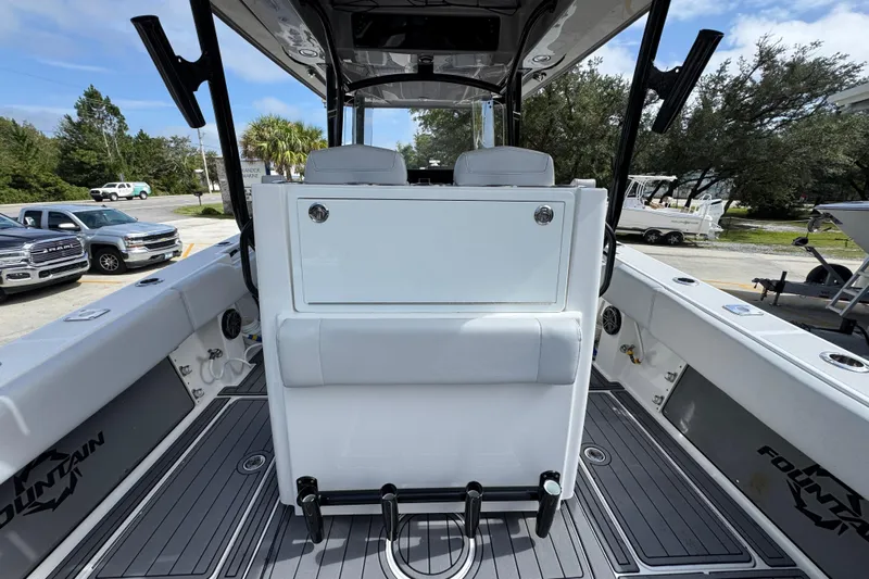 Yacht Photos Pics 2020 Fountain 38 Tournament Edition boat interior with seating and storage, parked outdoors.