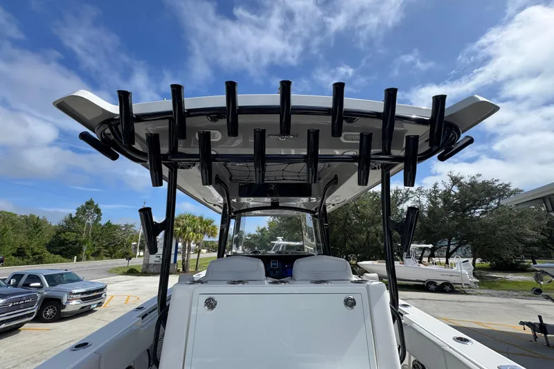  Yacht Photos Pics 2020 Fountain 38 Tournament Edition boat with rod holders, parked outdoors under a blue sky.