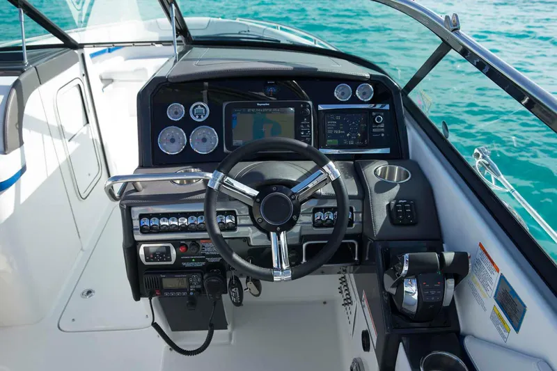  Yacht Photos Pics Manufacturer Provided Image: 2018 Formula 310 Bowrider dashboard with steering wheel and navigation controls on open water.