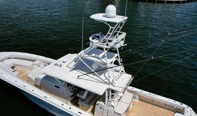 Strait To Voicemail Yacht Photos Pics 2018 HCB 53 Sueños boat with upper deck, docked on calm water.