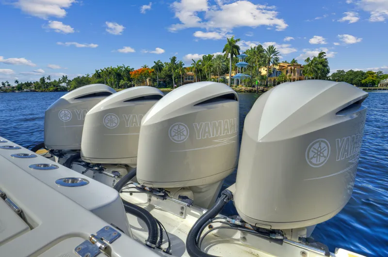 Strait To Voicemail Yacht Photos Pics Four Yamaha outboard engines on a 2018 HCB 53 Sueños boat, scenic waterfront background.