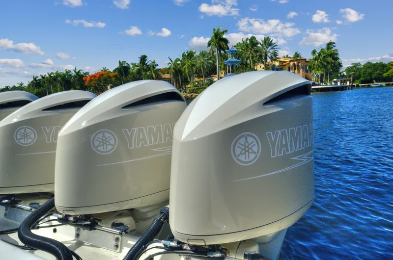 Strait To Voicemail Yacht Photos Pics Three Yamaha outboard motors on a 2018 HCB 53 Sueños boat by a tropical waterfront.