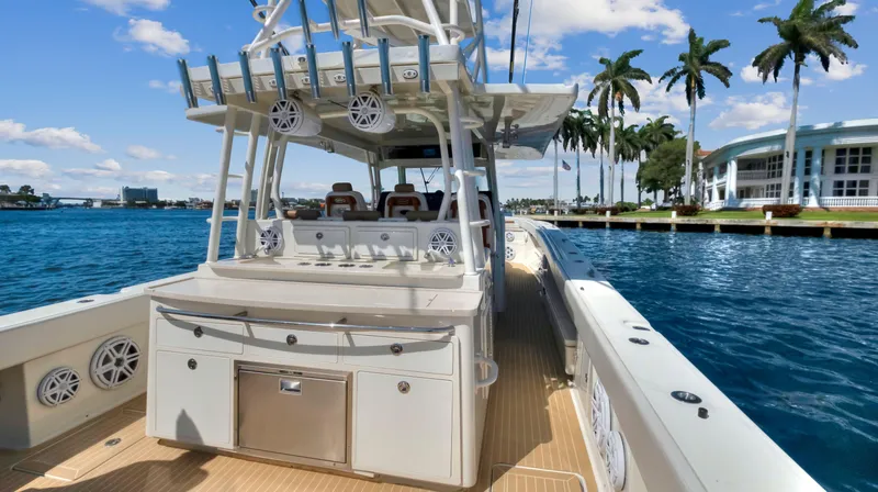 Strait To Voicemail Yacht Photos Pics 2018 HCB 53 Sueños boat docked by palm trees and waterfront buildings.