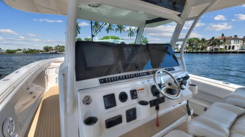Strait To Voicemail Yacht Photos Pics 2018 HCB 53 Sueños boat helm with modern navigation equipment.