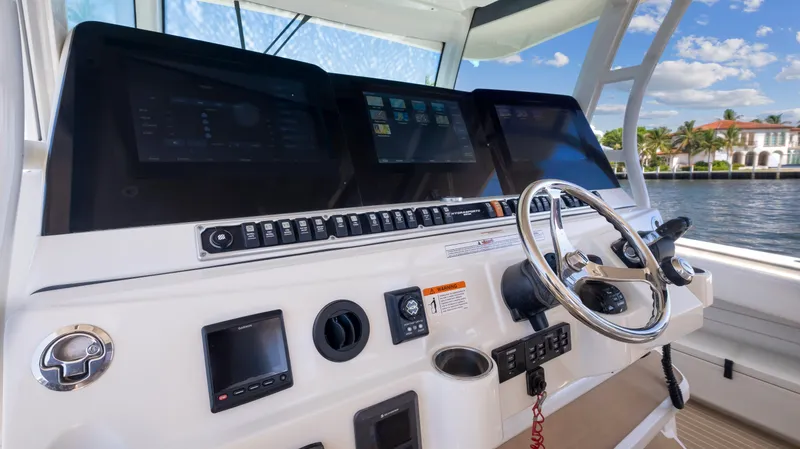 Strait To Voicemail Yacht Photos Pics 2018 HCB 53 Sueños boat helm with advanced navigation systems and steering wheel.