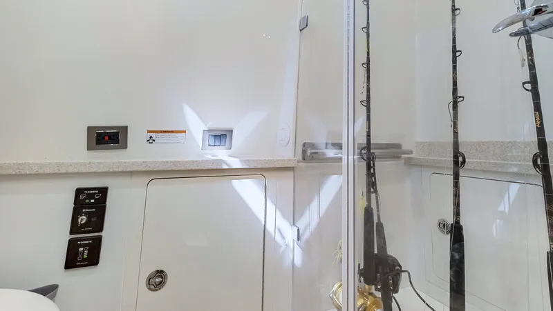 Strait To Voicemail Yacht Photos Pics Interior of 2018 HCB 53 Sueños boat with fishing rods and control panels.