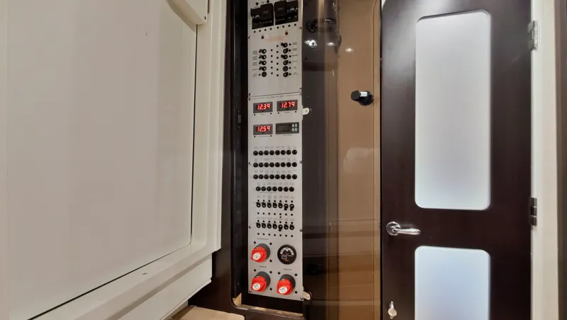 Strait To Voicemail Yacht Photos Pics Control panel inside 2018 HCB 53 Sueños boat with modern door and sleek design.