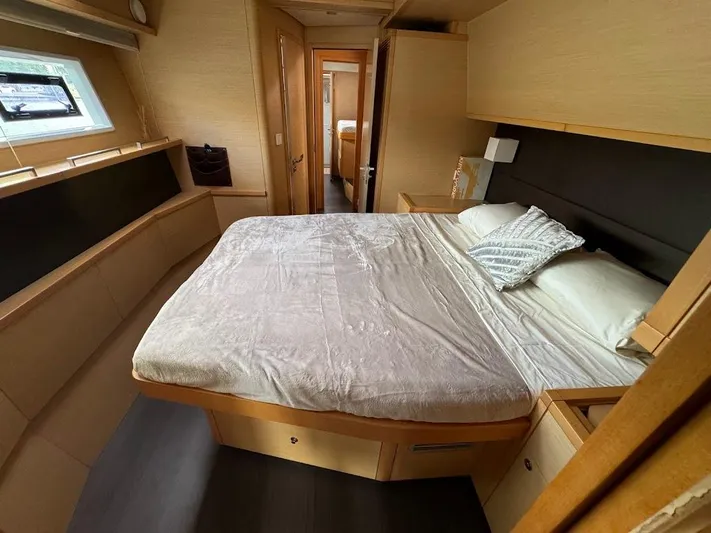 London Sky Yacht Photos Pics Luxurious bedroom interior of 2015 Lagoon Motor Yacht with cozy bed and modern design.