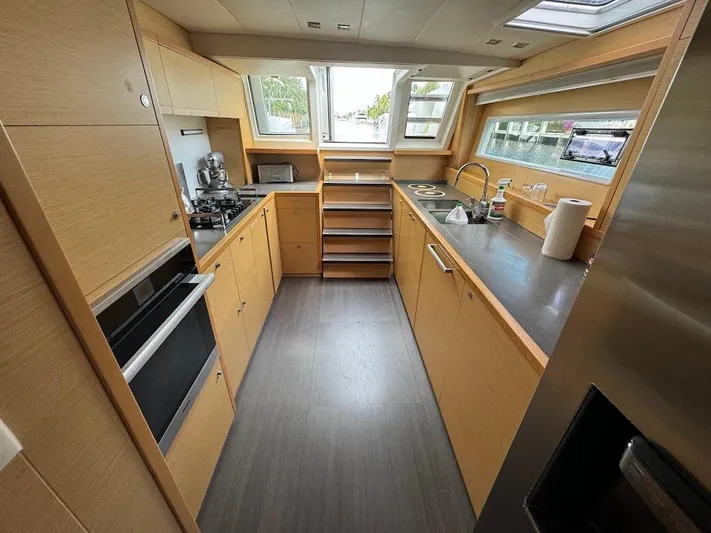London Sky Yacht Photos Pics Modern kitchen interior on 2015 Lagoon Motor Yacht, featuring sleek cabinetry and appliances.