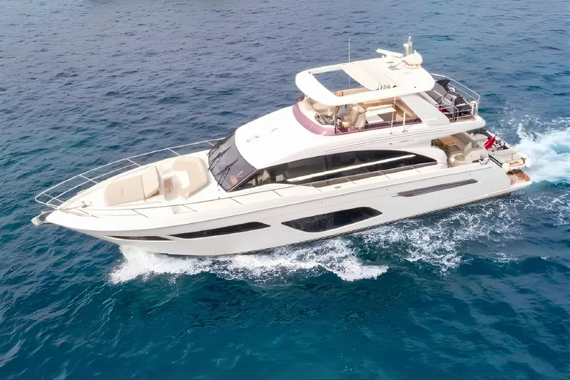  Yacht Photos Pics Luxurious 2019 Princess F70 yacht cruising on clear blue ocean waters.