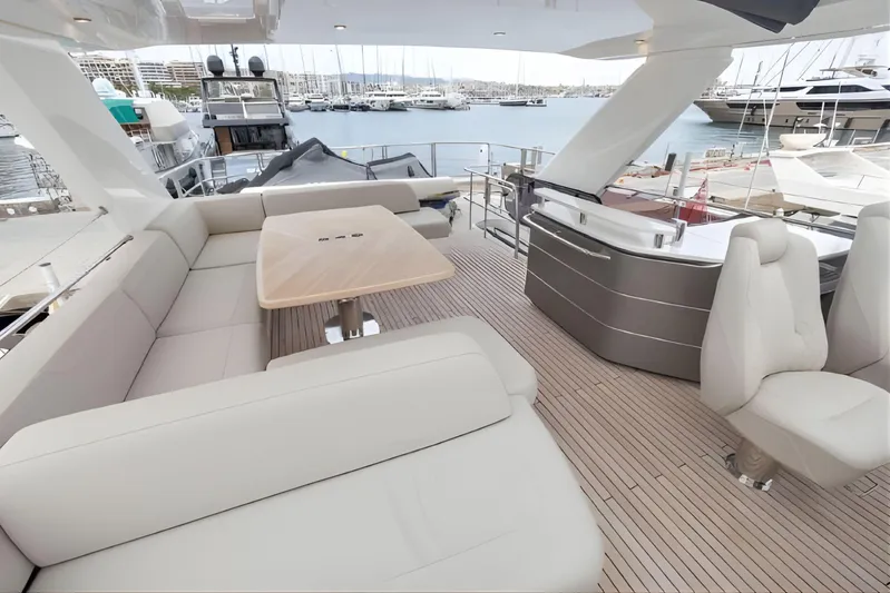  Yacht Photos Pics Luxurious 2019 Princess F70 yacht deck with seating, table, and marina view.