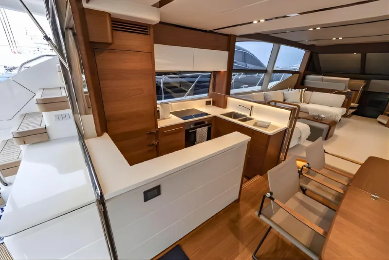  Yacht Photos Pics Luxurious interior of a 2019 Princess F70 yacht with modern kitchen and seating area.