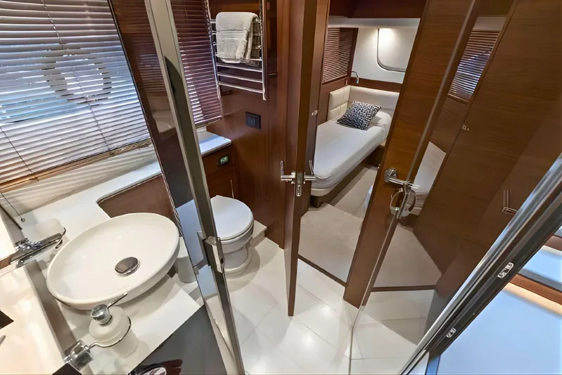  Yacht Photos Pics Luxurious interior of 2019 Princess F70 yacht featuring bathroom and cozy bedroom.