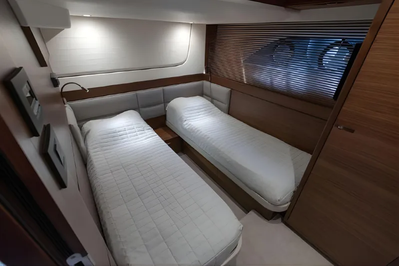  Yacht Photos Pics Luxurious twin cabin interior on 2019 Princess F70 yacht, featuring modern design and cozy bedding.