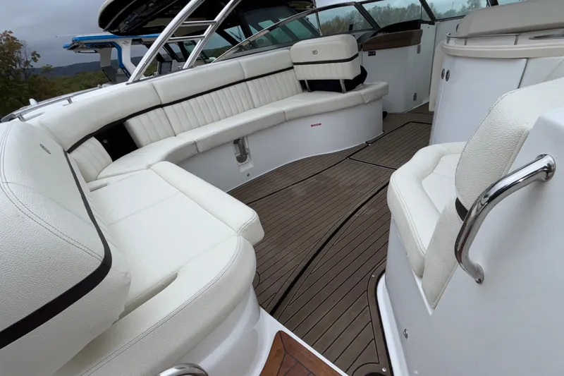  Yacht Photos Pics Luxurious interior of 2022 Cobalt R35 boat with white seating and wooden flooring.