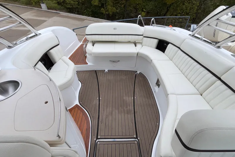  Yacht Photos Pics Luxurious 2022 Cobalt R35 boat interior with elegant white seating and wooden flooring.