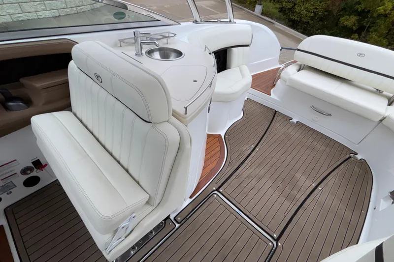  Yacht Photos Pics 2022 Cobalt R35 boat interior with white seating and wood flooring.
