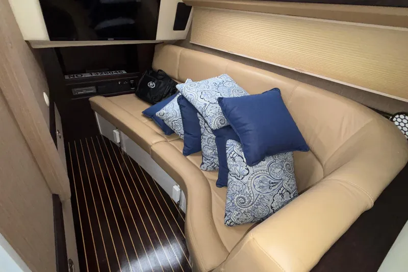  Yacht Photos Pics Luxurious interior of 2022 Cobalt R35 with beige seating and decorative pillows.