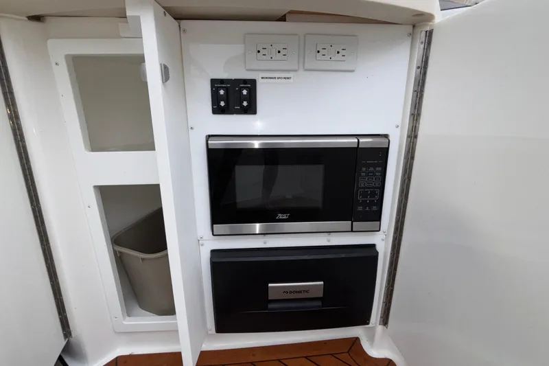  Yacht Photos Pics 2022 Cobalt R35 interior with microwave and storage cabinet.