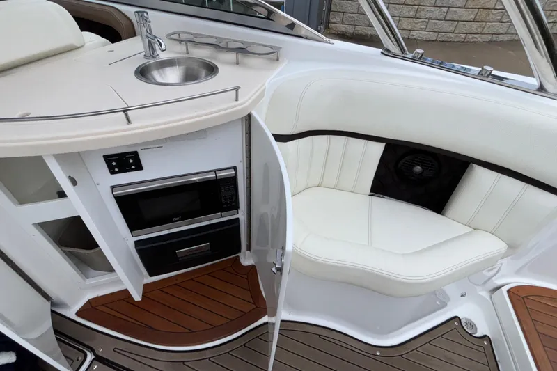  Yacht Photos Pics 2022 Cobalt R35 boat interior with kitchenette, sink, and seating area.