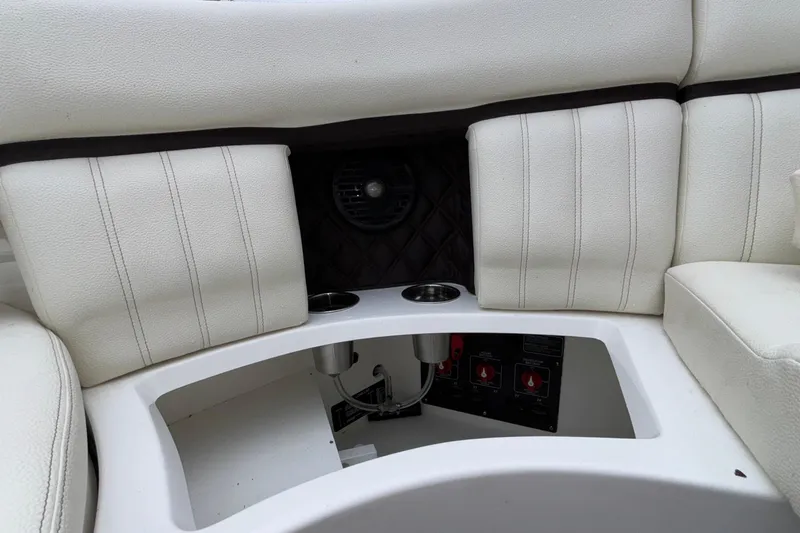  Yacht Photos Pics 2022 Cobalt R35 boat interior with white cushioned seating and cup holders.