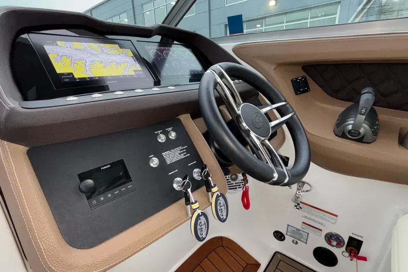  Yacht Photos Pics 2022 Cobalt R35 boat dashboard with steering wheel, navigation screens, and control panel.