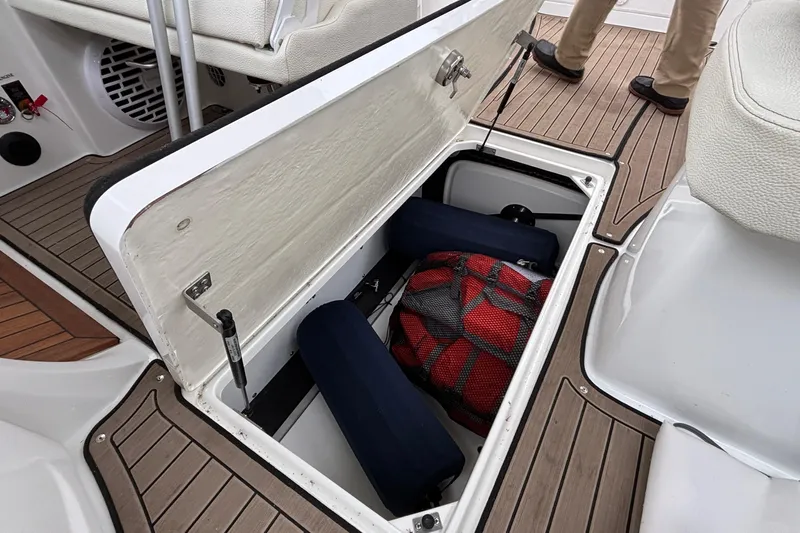  Yacht Photos Pics Cobalt R35 2022 boat storage compartment with life jackets and gear on deck.