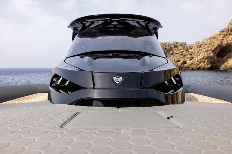  Yacht Photos Pics 2024 SACS Strider 15 luxury yacht, sleek design, docked by rocky coastline.