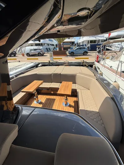  Yacht Photos Pics Luxurious 2024 SACS Strider 15 yacht interior with elegant seating and wooden tables.