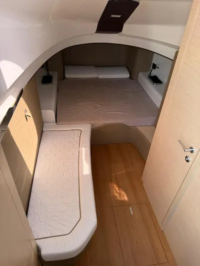  Yacht Photos Pics 2024 SACS Strider 15 cabin interior with bed and seating area.