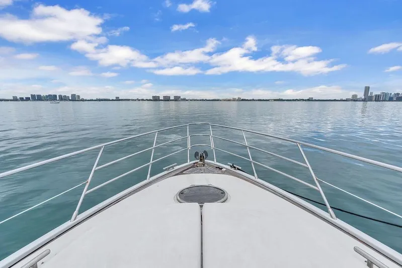  Yacht Photos Pics Bow view of 2006 Azimut 68S yacht cruising on calm waters under blue sky.