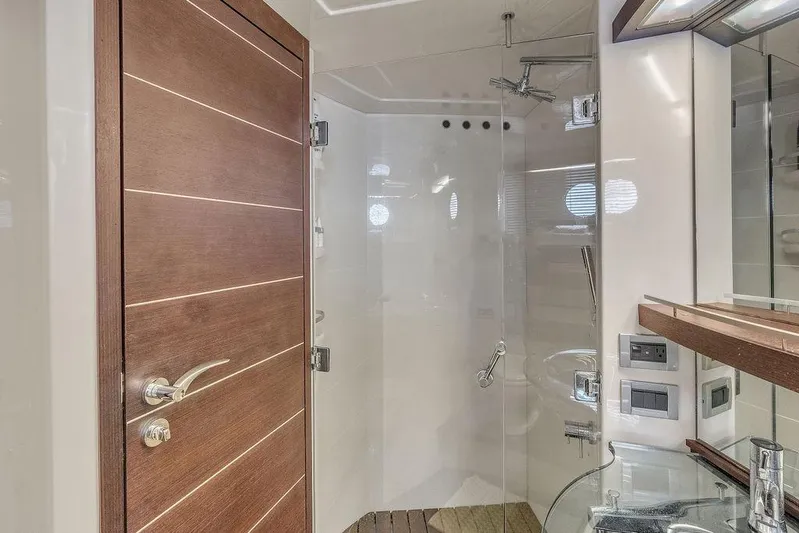  Yacht Photos Pics Luxurious bathroom on 2006 Azimut 68S yacht with glass shower and wooden accents.