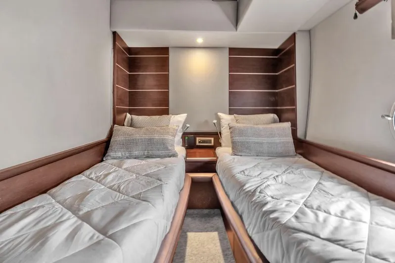  Yacht Photos Pics Luxurious twin cabin interior on a 2006 Azimut 68S yacht, featuring elegant wood paneling.