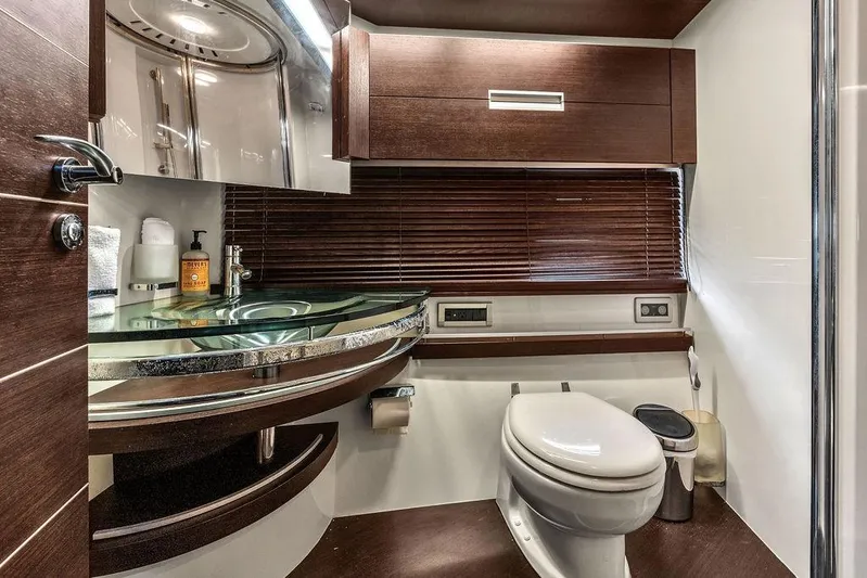  Yacht Photos Pics Luxurious bathroom in 2006 Azimut 68S yacht with modern fixtures and elegant wood accents.