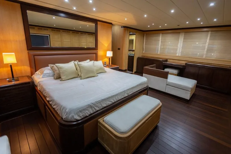  Yacht Photos Pics Luxurious bedroom interior on 2004 Mangusta 108 yacht with elegant wood finishes.