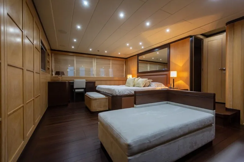  Yacht Photos Pics Luxurious 2004 Mangusta 108 yacht bedroom with modern lighting and elegant wood paneling.
