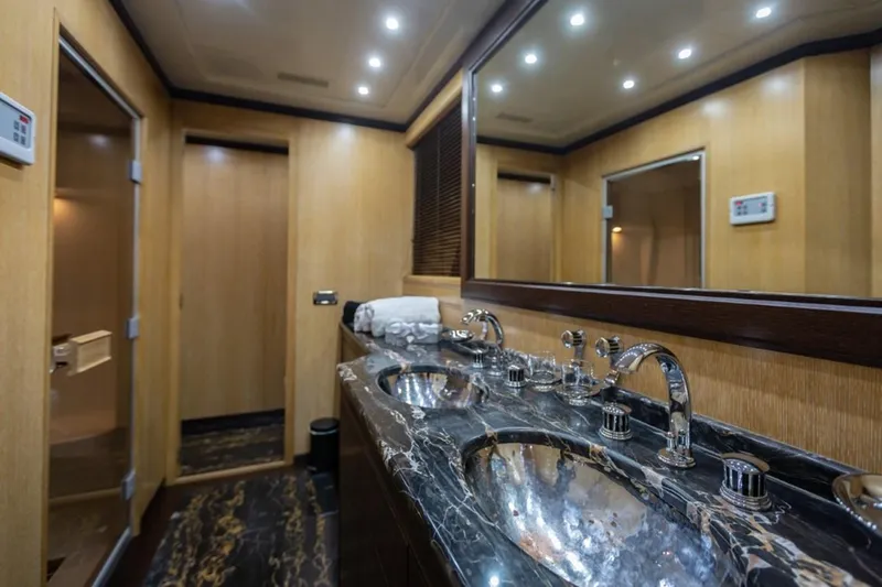  Yacht Photos Pics Luxurious bathroom in 2004 Mangusta 108 yacht with marble countertop and modern fixtures.