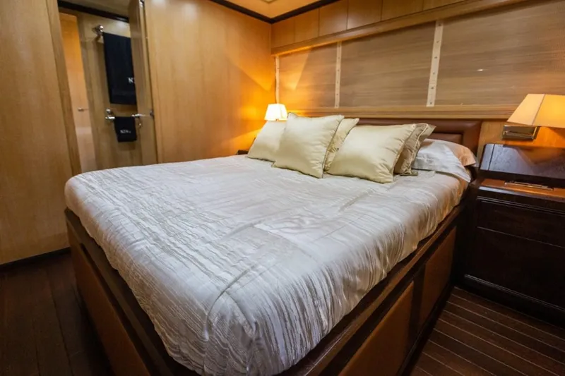  Yacht Photos Pics Luxurious bedroom interior on 2004 Mangusta 108 yacht with cozy lighting and elegant bedding.