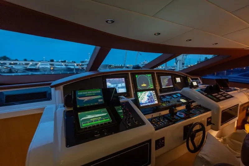  Yacht Photos Pics Cockpit of 2004 Mangusta 108 yacht with advanced navigation systems at dusk.