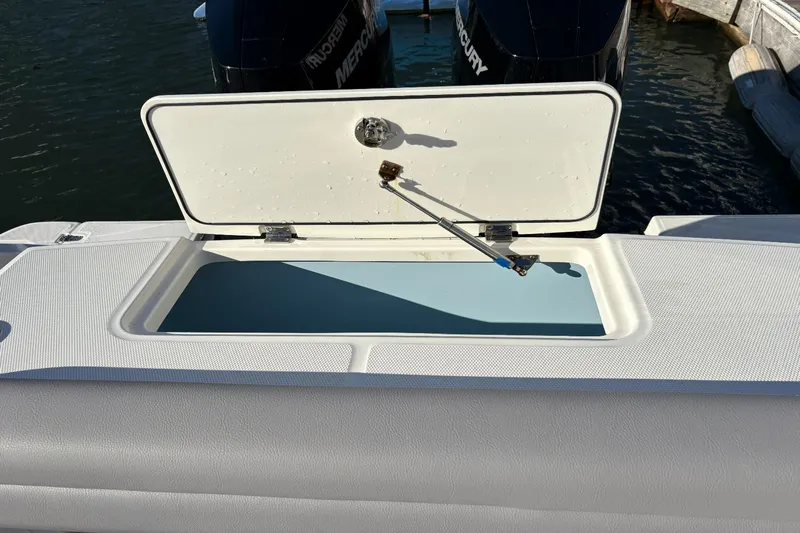  Yacht Photos Pics Boston Whaler 330R 2024 with open storage hatch at the stern.