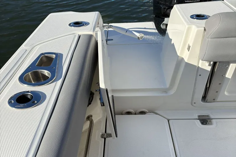  Yacht Photos Pics Boston Whaler 330R 2024, boat detailing with cup holders and seating area.