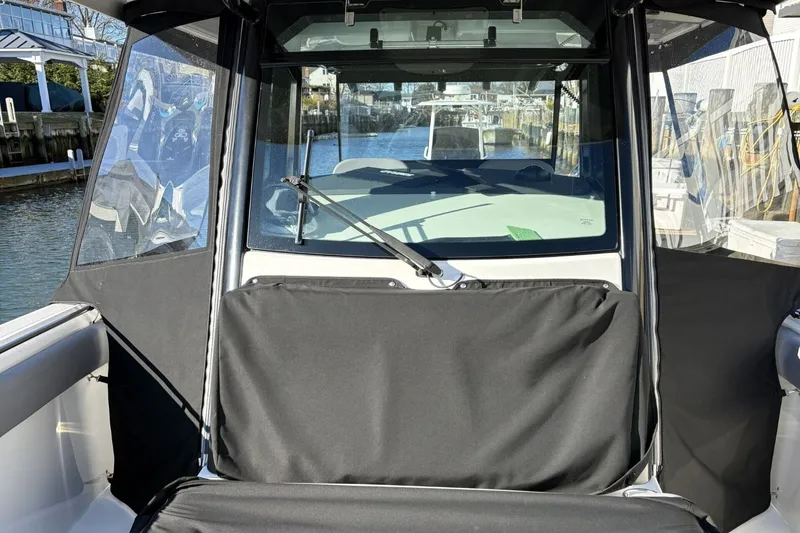  Yacht Photos Pics 2024 Boston Whaler 330R boat cockpit with cover in harbor.