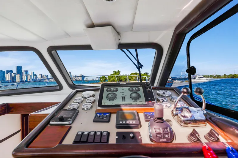 Miss Cathy Yacht Photos Pics Custom NNS Sea Scout 41 yacht cockpit, 2007 model, with city skyline and water view.