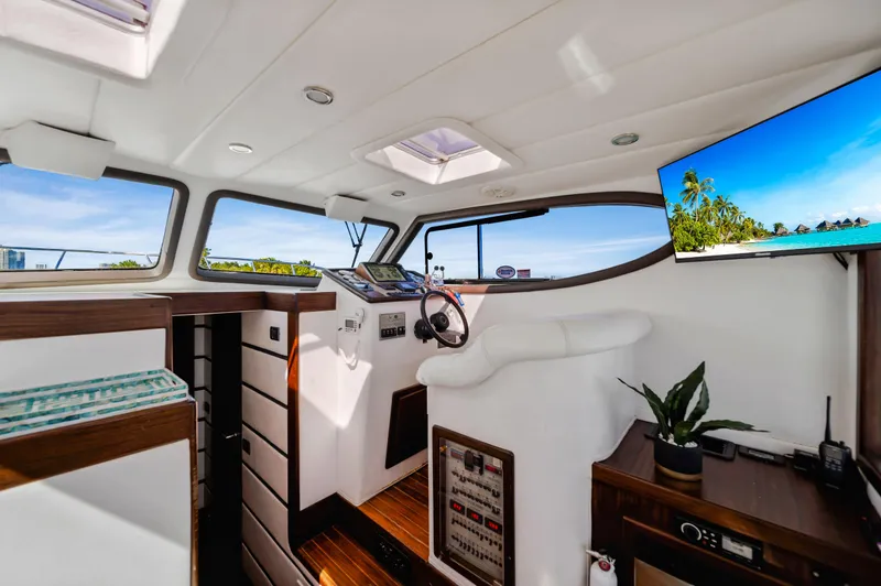 Miss Cathy Yacht Photos Pics Interior of 2007 Custom NNS Sea Scout 41 yacht with modern helm and tropical view.